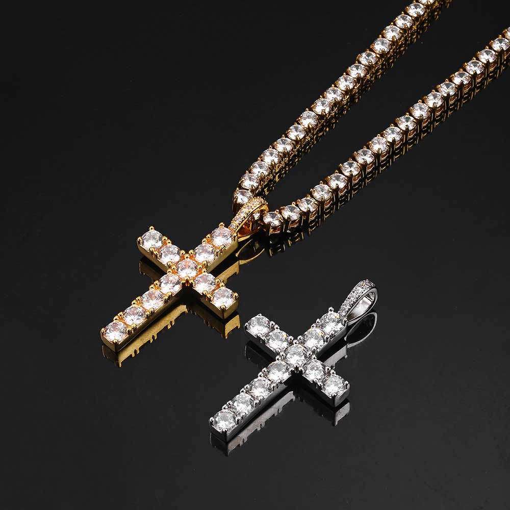 Gold cross pendants with diamond accents on a black background