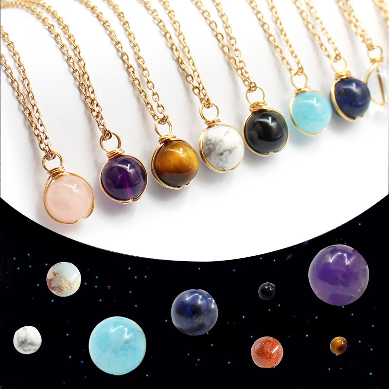 Necklaces with colorful gemstones on a celestial-themed background