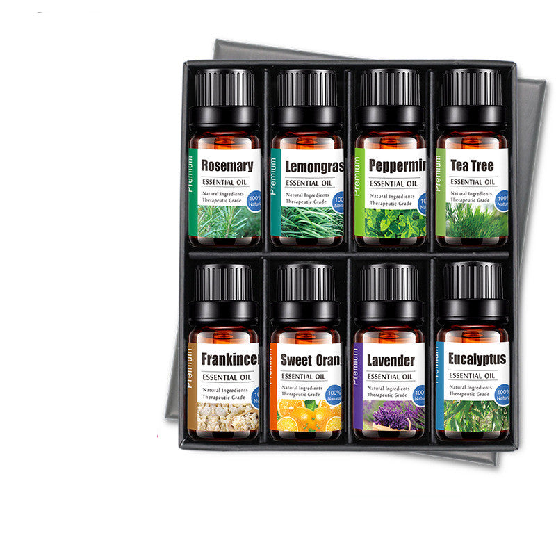 Set of essential oil bottles in a display box on a white background