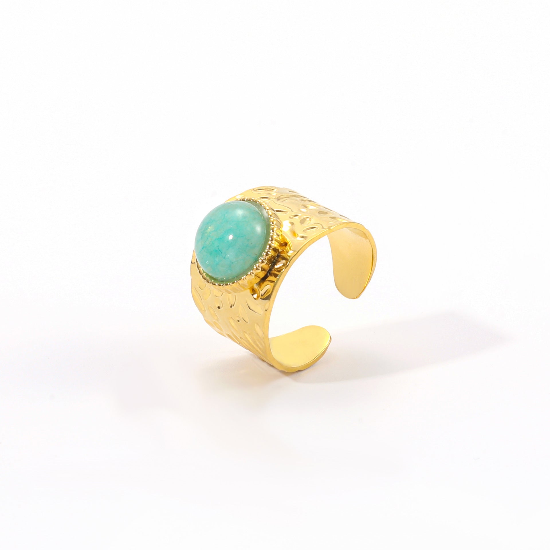 Gold ring with a turquoise stone on a white background