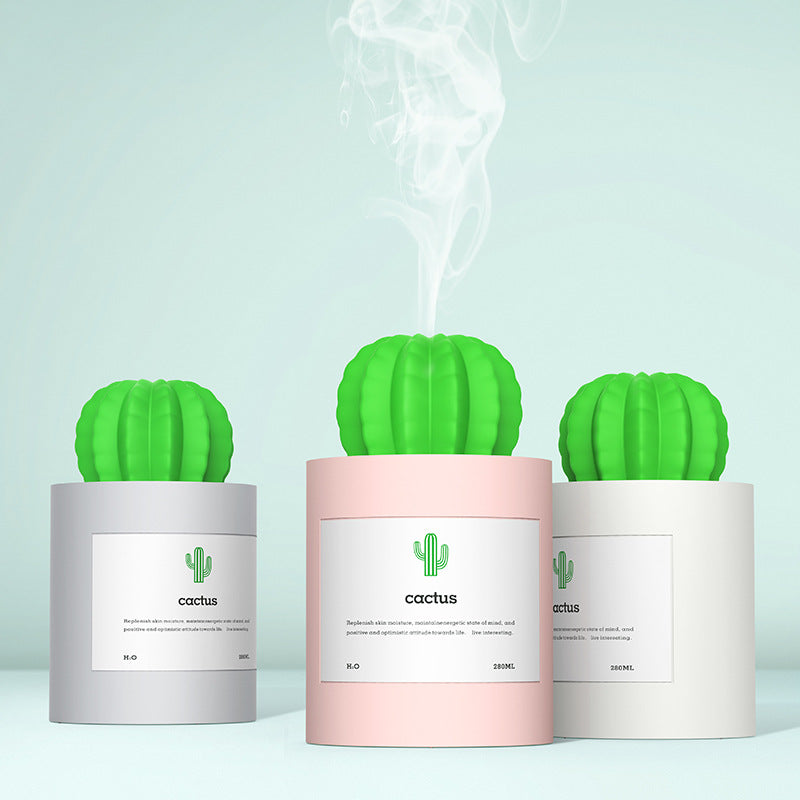 Three cactus-shaped diffusers on a light blue background