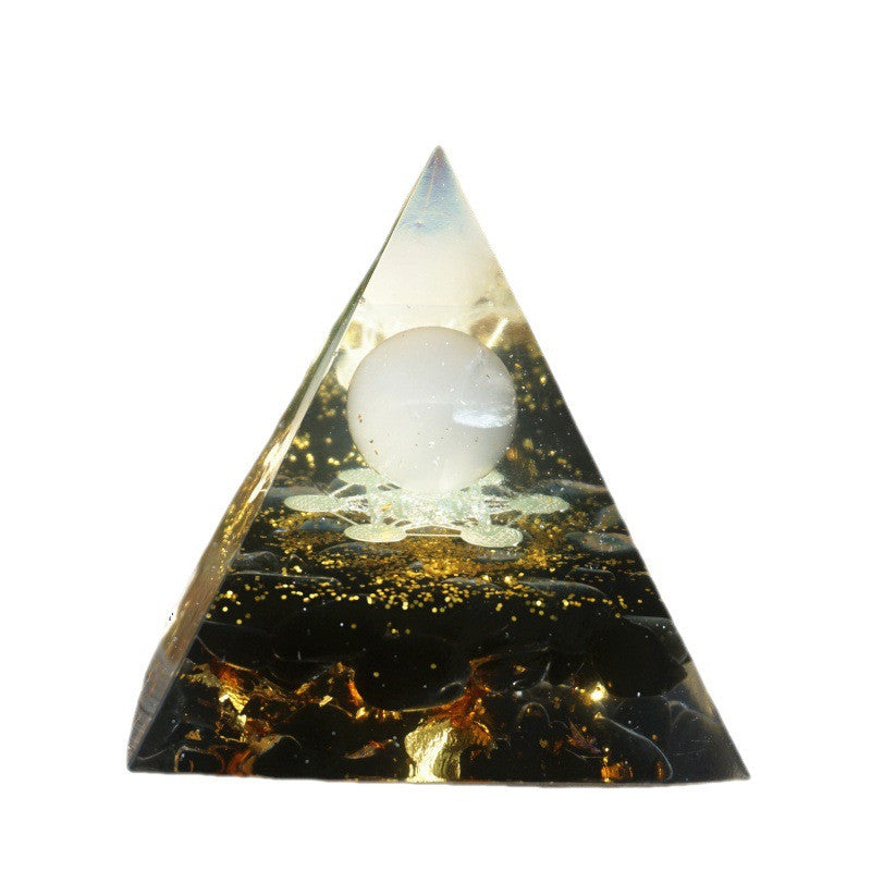 Pyramid-shaped crystal with a white sphere inside on a white background