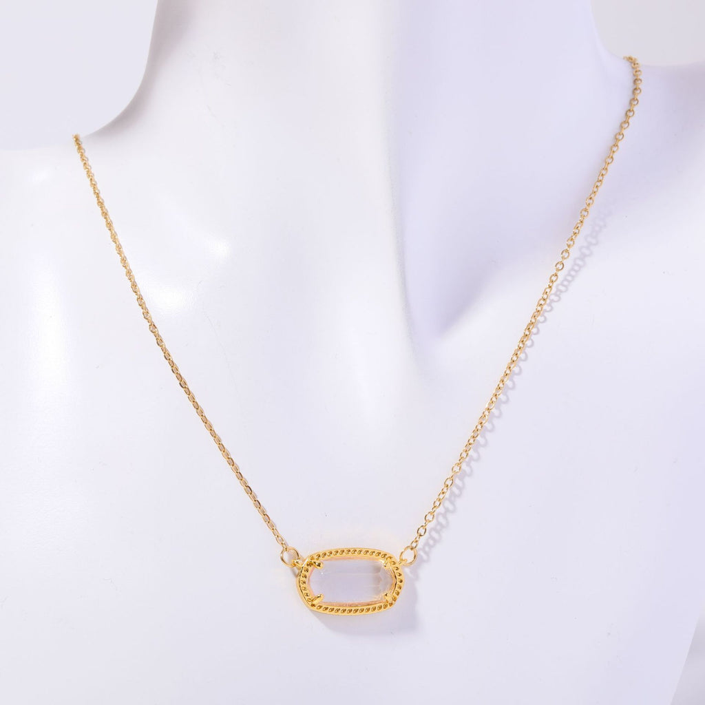 Gold necklace with a unique pendant on a white background