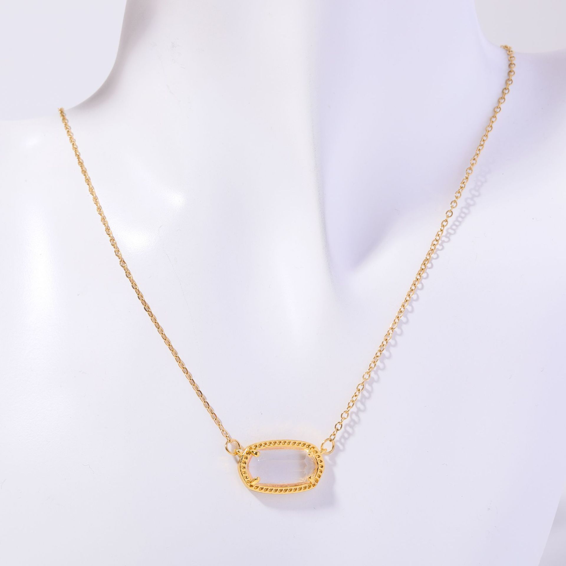 Gold necklace with a unique pendant on a white background
