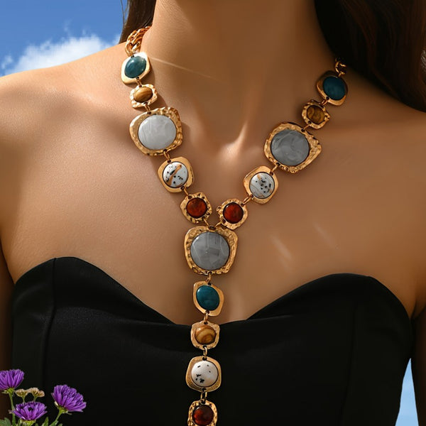 Necklace with multicolored stones on a person against a blue sky background