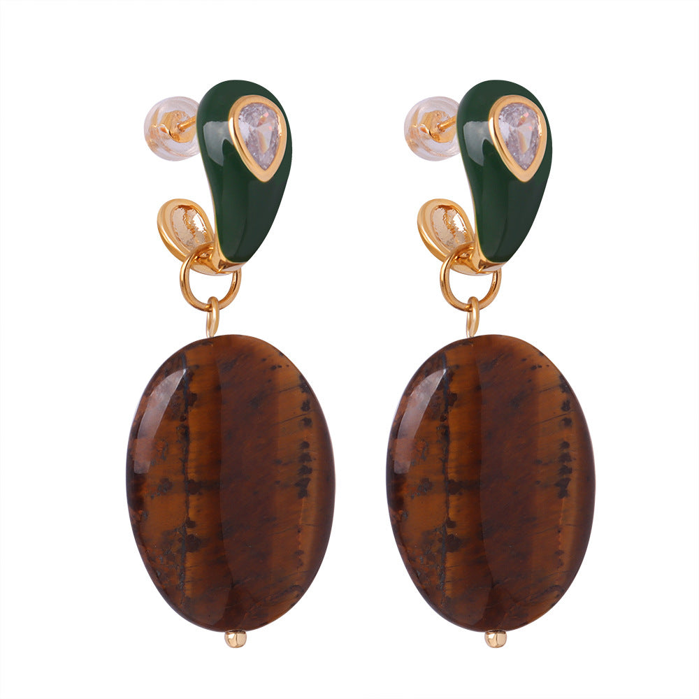 Pair of earrings with green and brown stones on a white background