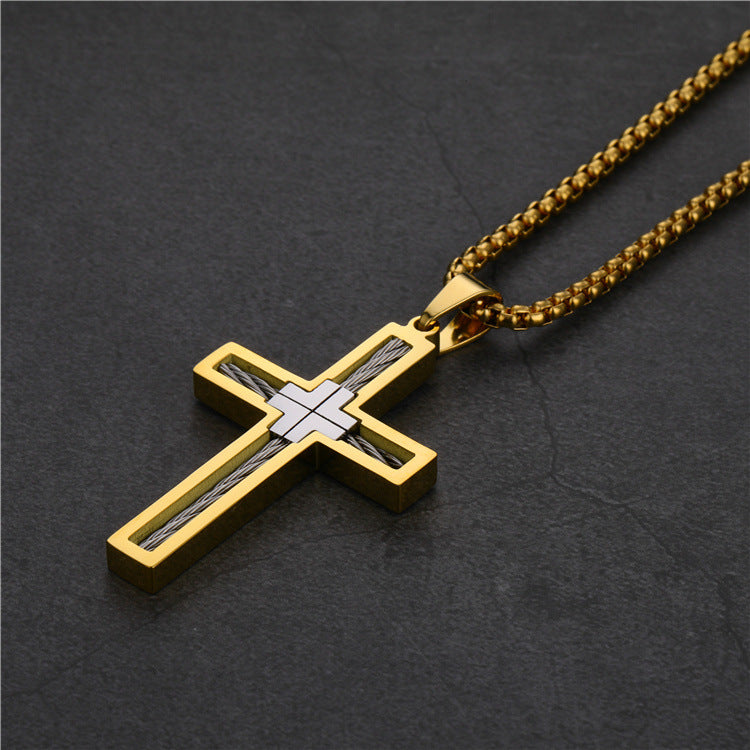 Gold and silver cross pendant on a dark background
