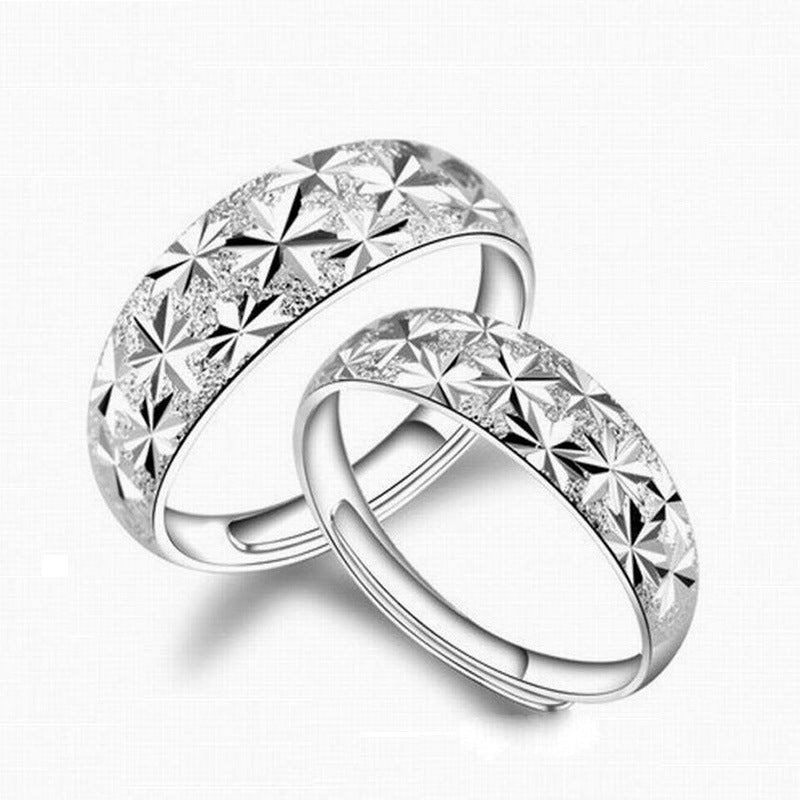 Two silver rings with diamond-like patterns on a white background