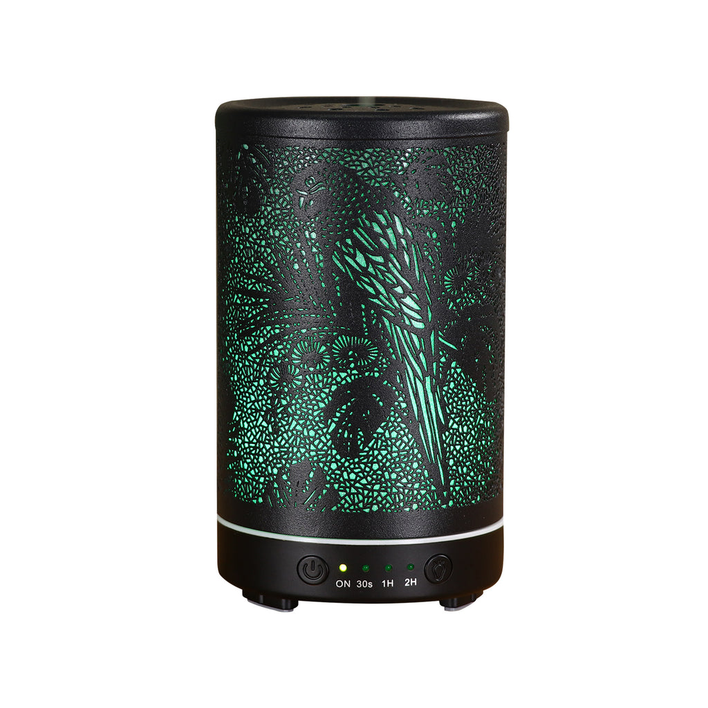 Black diffuser with green design on a white background