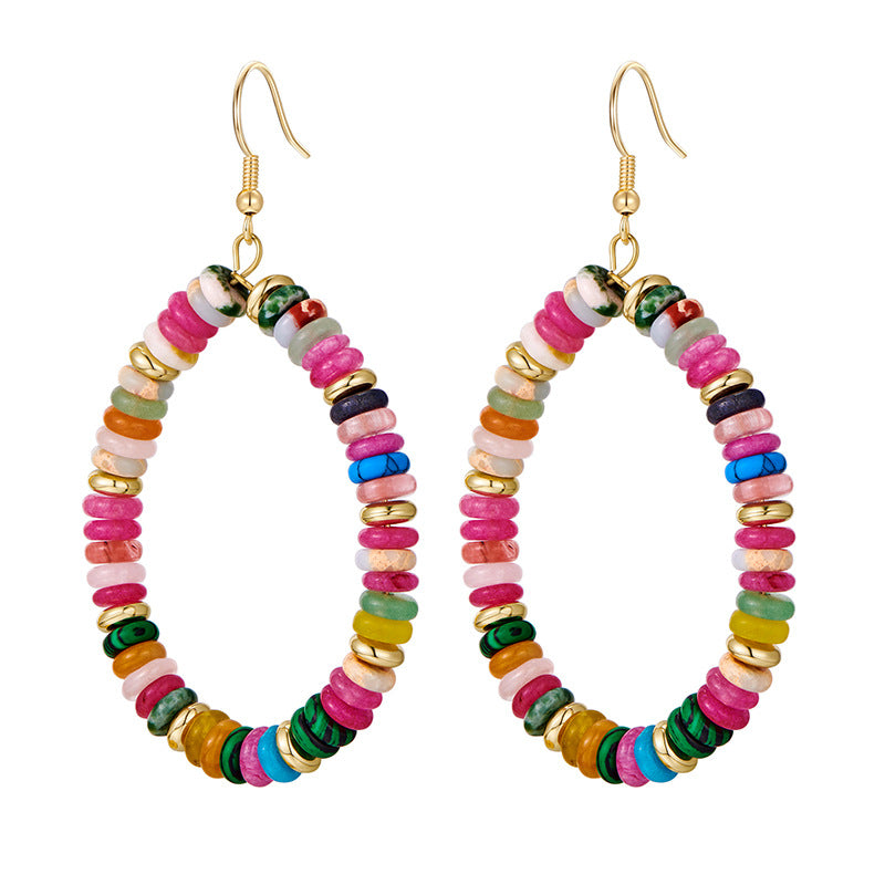 Colorful beaded hoop earrings with gold accents on a white background
