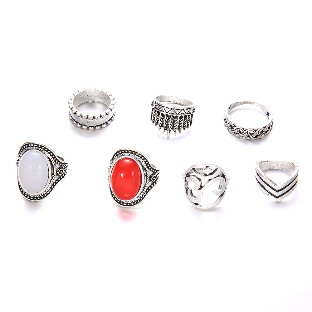 Set of silver rings with various designs on a white background