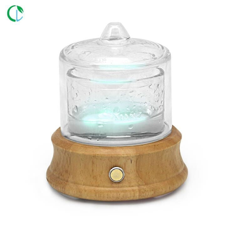 Glass candle holder with wooden base on a white background