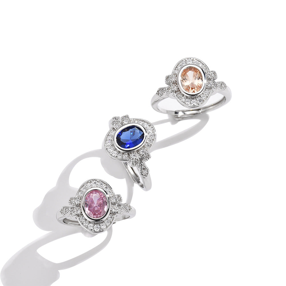 Three rings with different colored gemstones on a white background