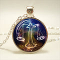 Necklace with a pendant featuring a design of a woman holding scales against a starry background.
