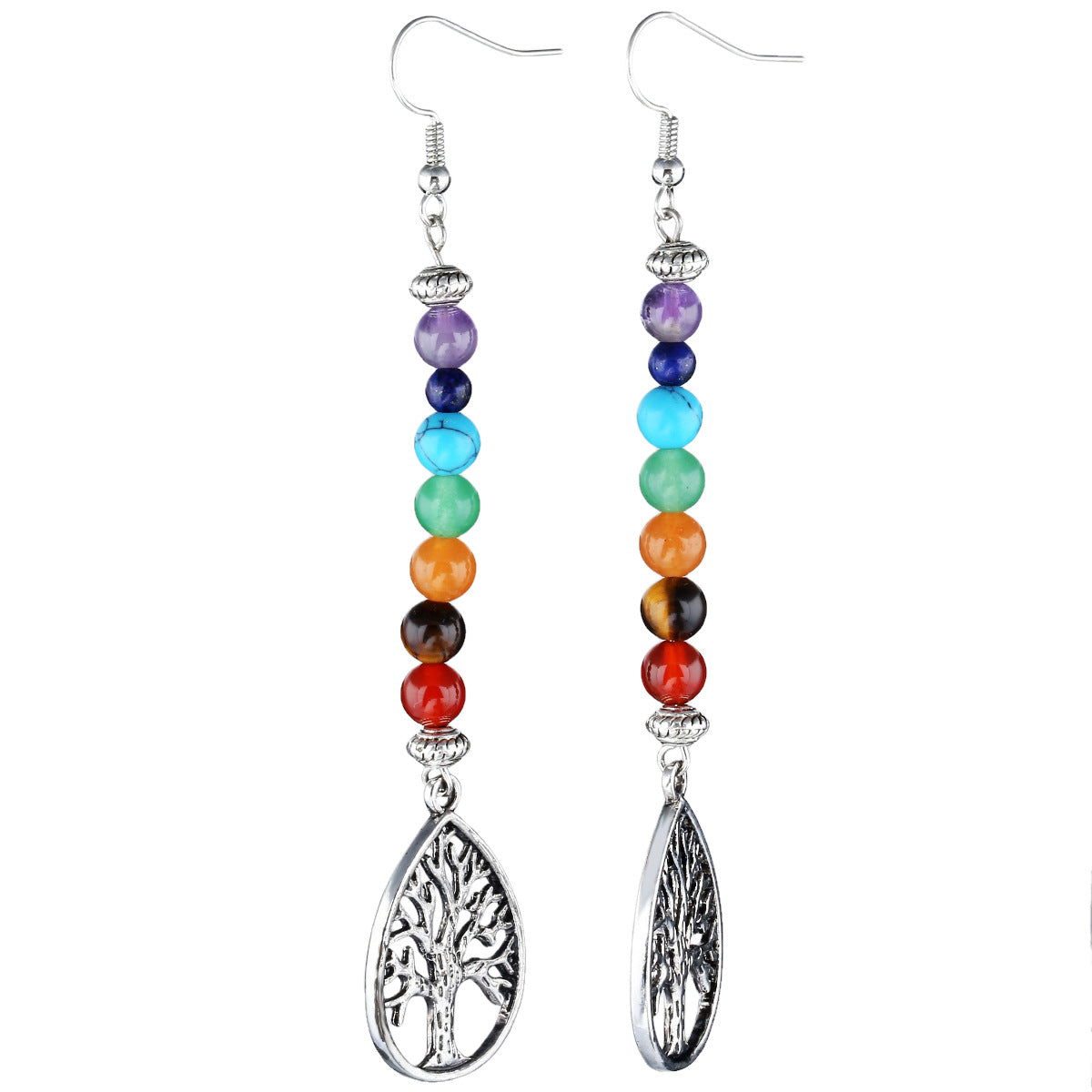 Pair of beaded earrings with tree of life charms on a white background