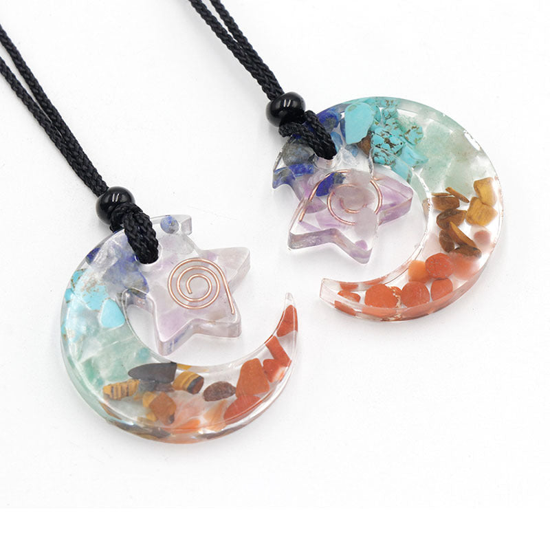 Two colorful stone pendants on black cords against a white background