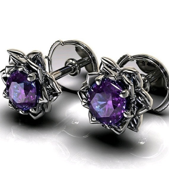 Silver earrings with purple gemstones on a white background