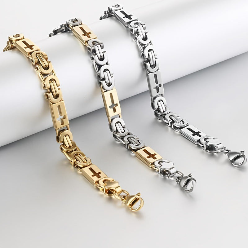 Two gold and silver chain bracelets on a light gray surface.
