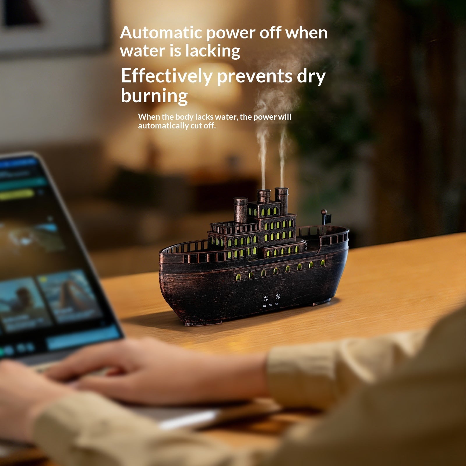 Wooden ship model with steam on a table next to a laptop, with text about automatic power off when water is lacking.