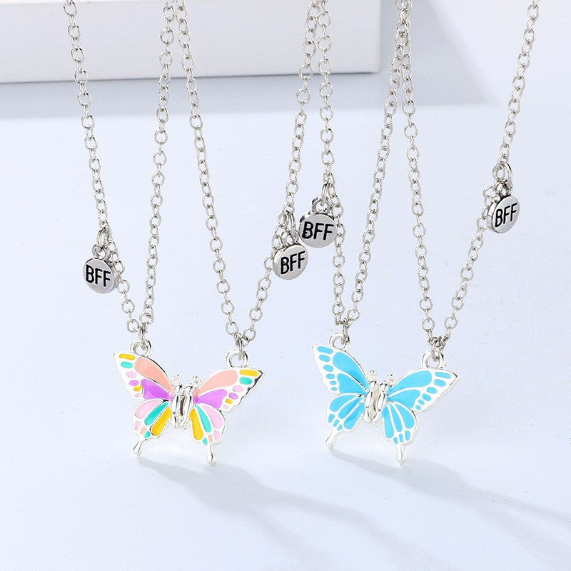 Butterfly necklaces with 'BFF' charms on a white background