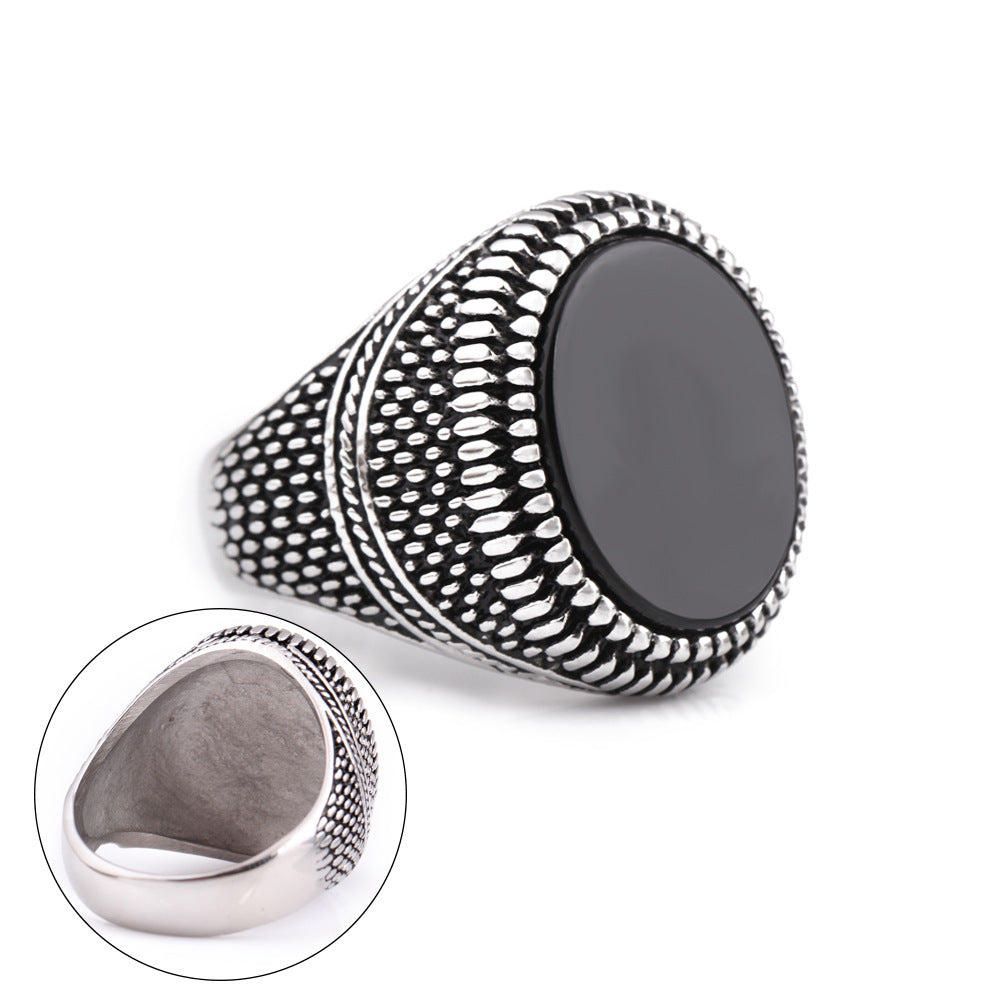 Silver ring with black stone on a white background