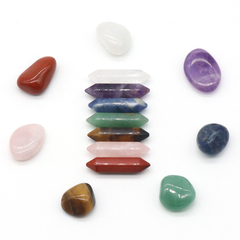 Set of colorful crystals arranged in a vertical stack on a white background