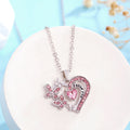 Necklace with pink heart and butterfly pendant on a white stand with a light blue background