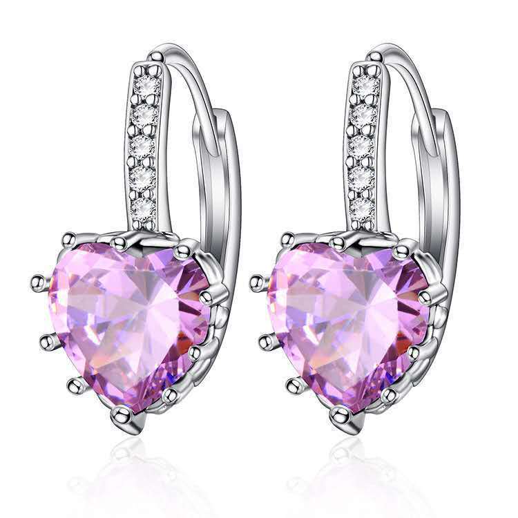 Pair of heart-shaped purple gemstone earrings with silver hooks on a white background