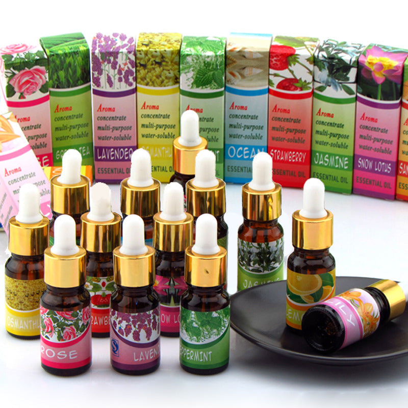 Assorted essential oil bottles with colorful labels on a white background