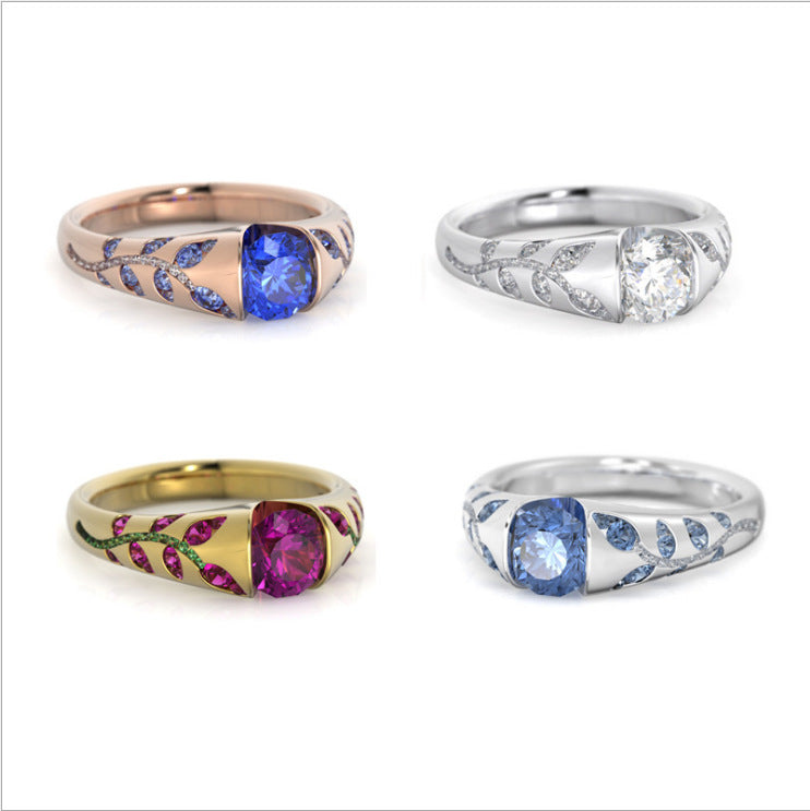 Four intricately designed rings with gemstones on a white background