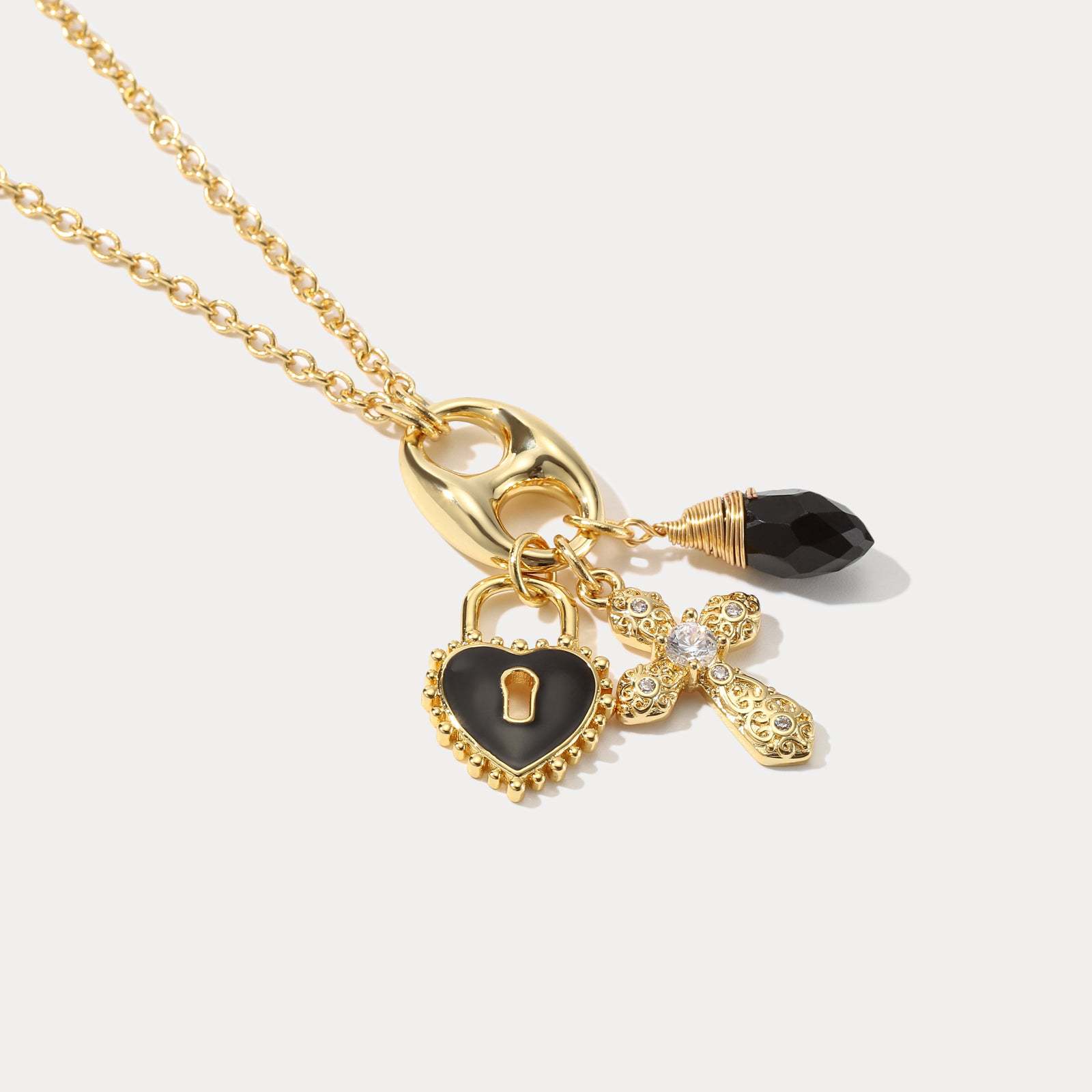 Gold necklace with heart-shaped lock charm on a light beige background