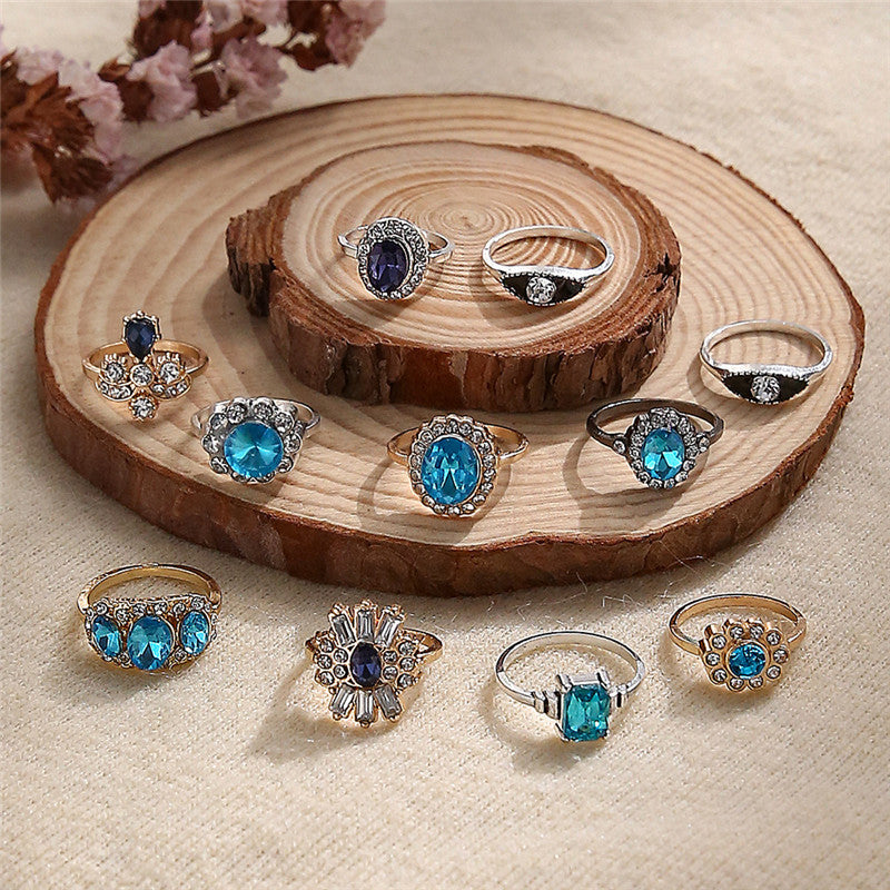 Collection of rings with gemstones on a wooden surface