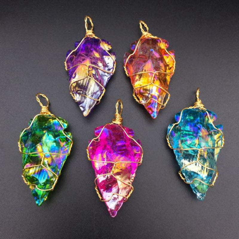 Five colorful crystal pendants on a dark background