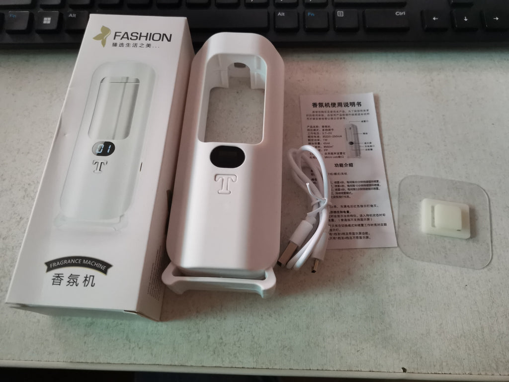 White electronic device with packaging and user manual on a desk