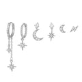Set of silver earrings with star and moon designs on a white background