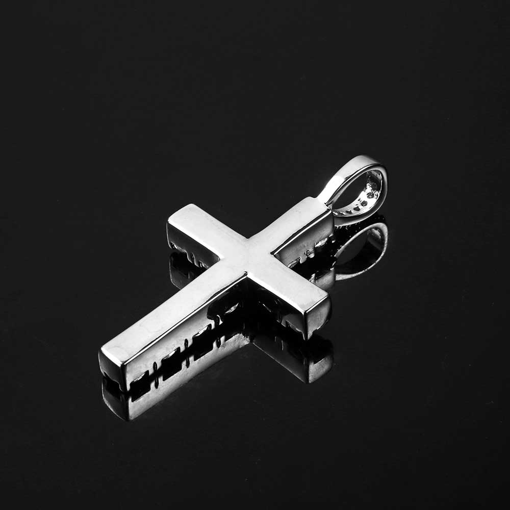 Silver cross pendant on a black background
