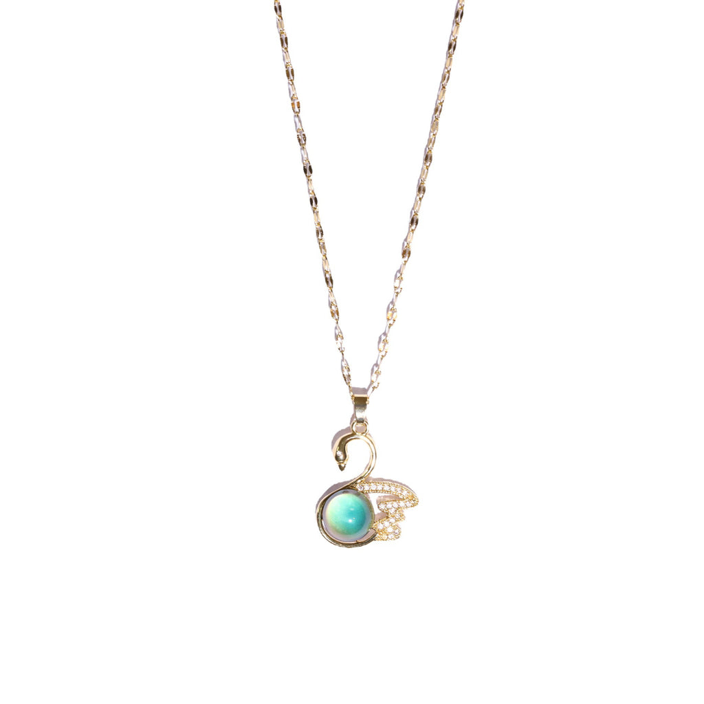 Necklace with a pendant featuring a green gemstone on a white background