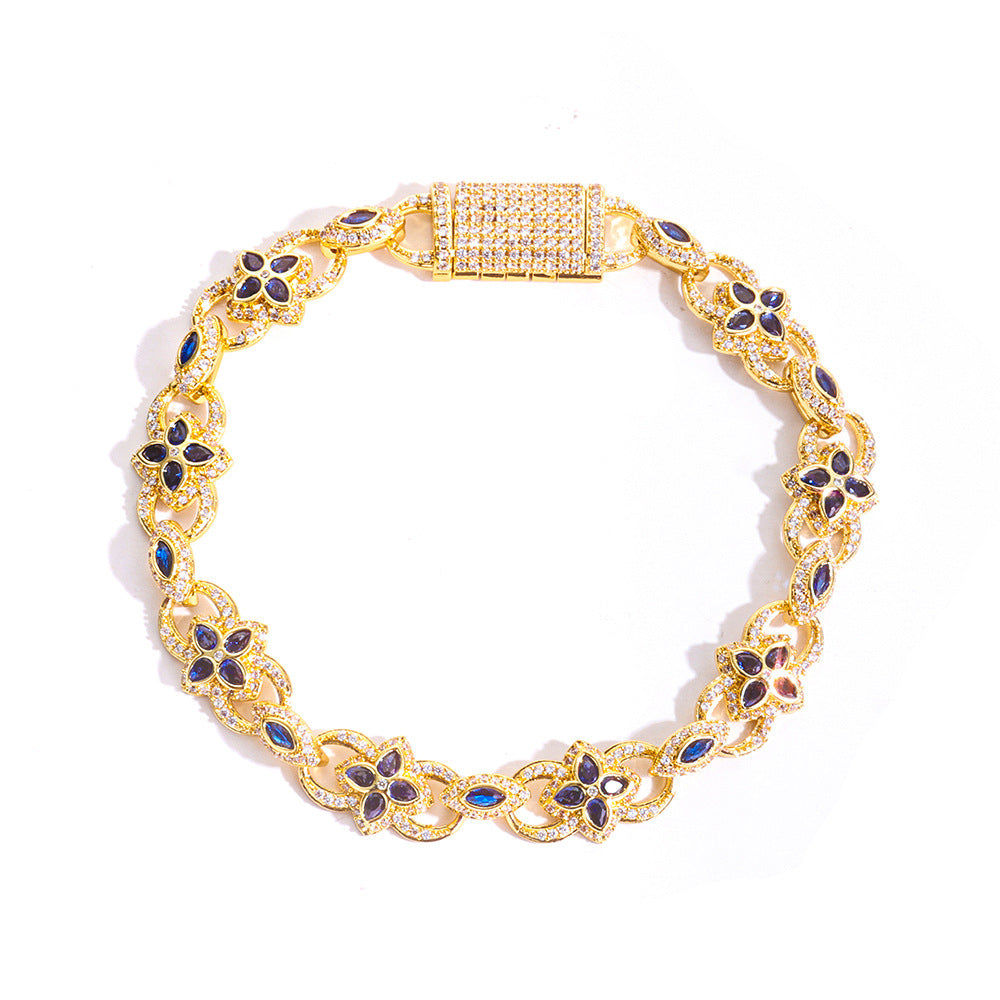 Gold bracelet with blue stones on a white background