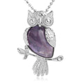 Silver owl pendant with a purple stone on a white background