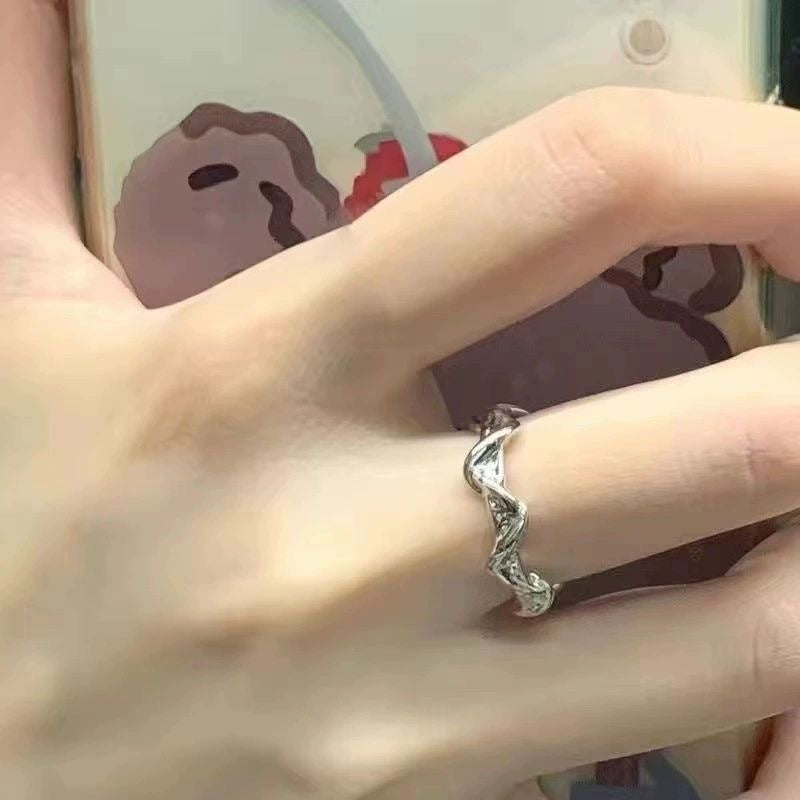 Silver ring on a finger with a blurred background