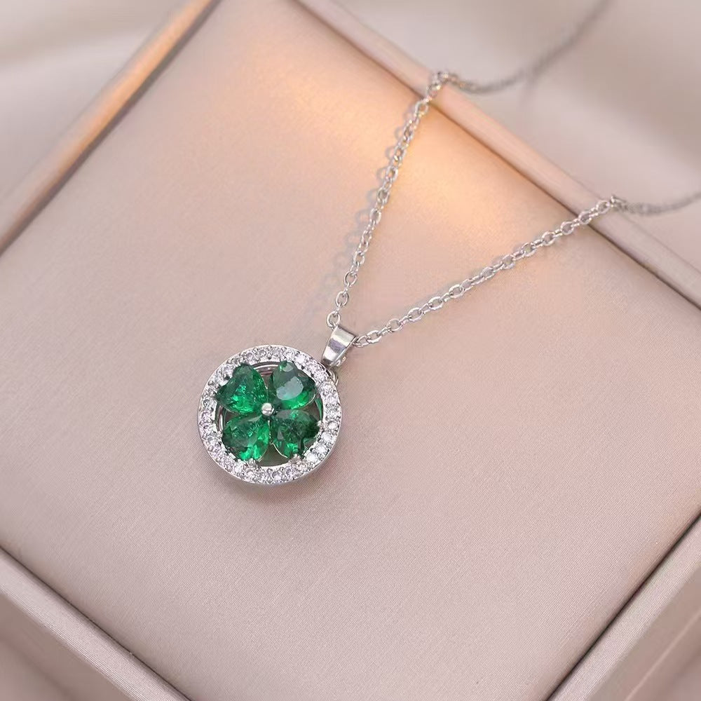 Silver necklace with a green gemstone pendant on a beige surface