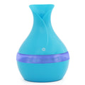 Turquoise and purple vase-shaped humidifier on a white background