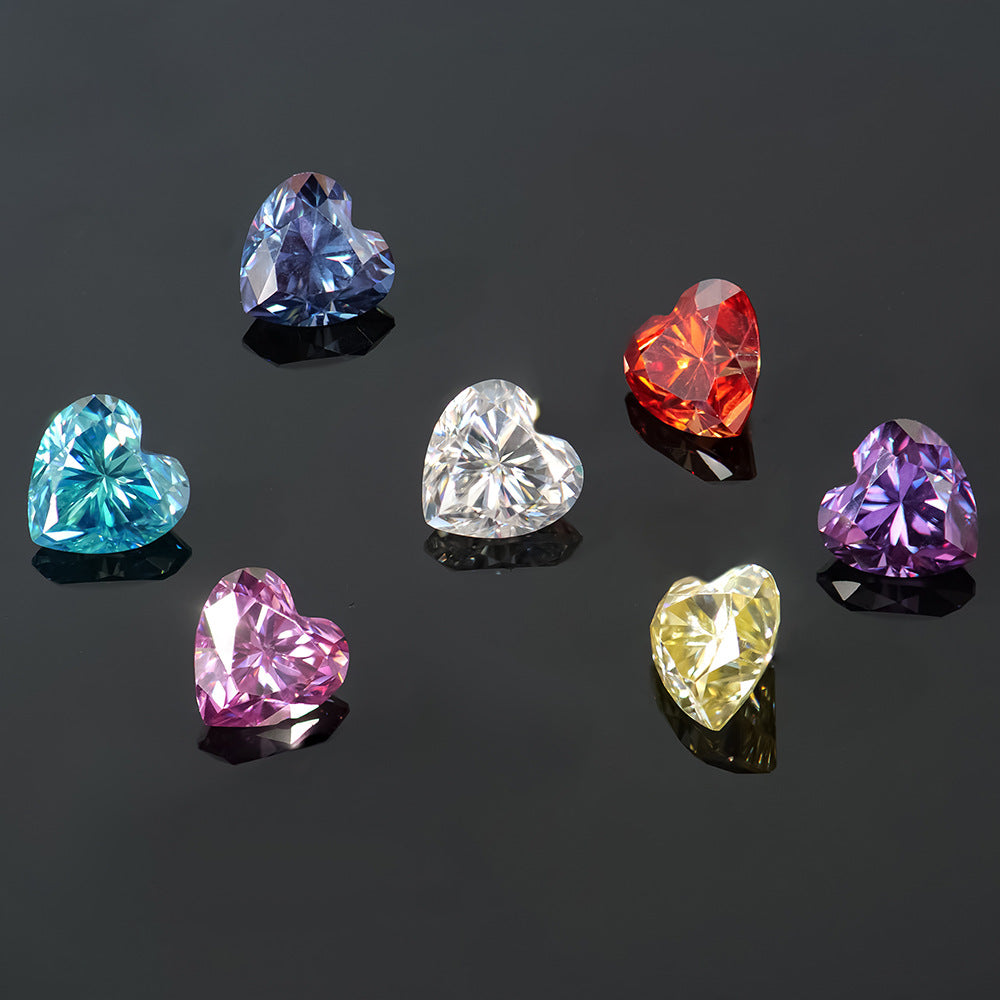 Heart-shaped gemstones in various colors on a black background