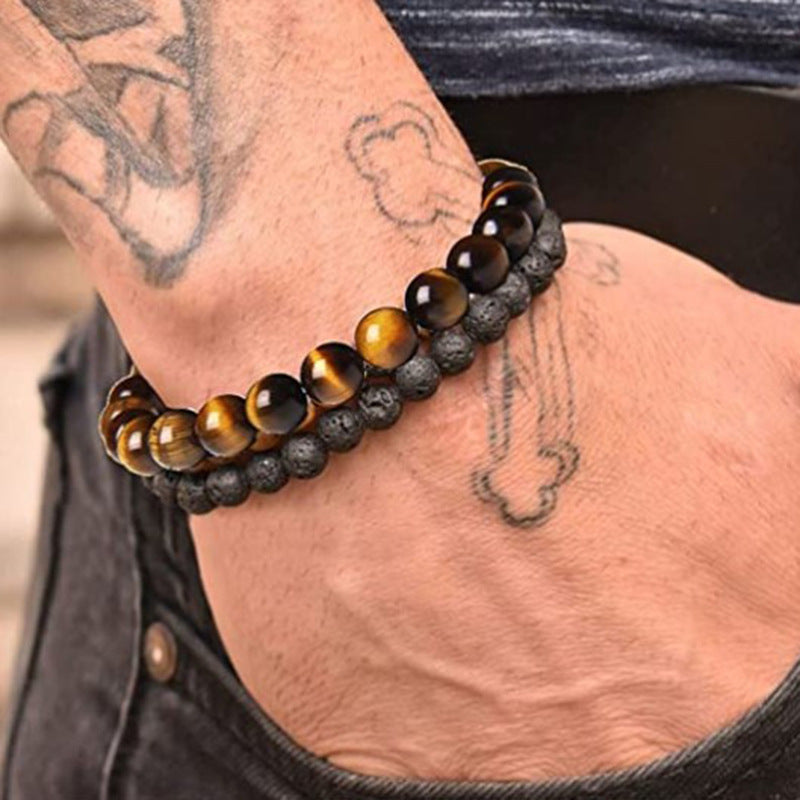 Bracelet with tiger eye beads on a wrist with tattoos