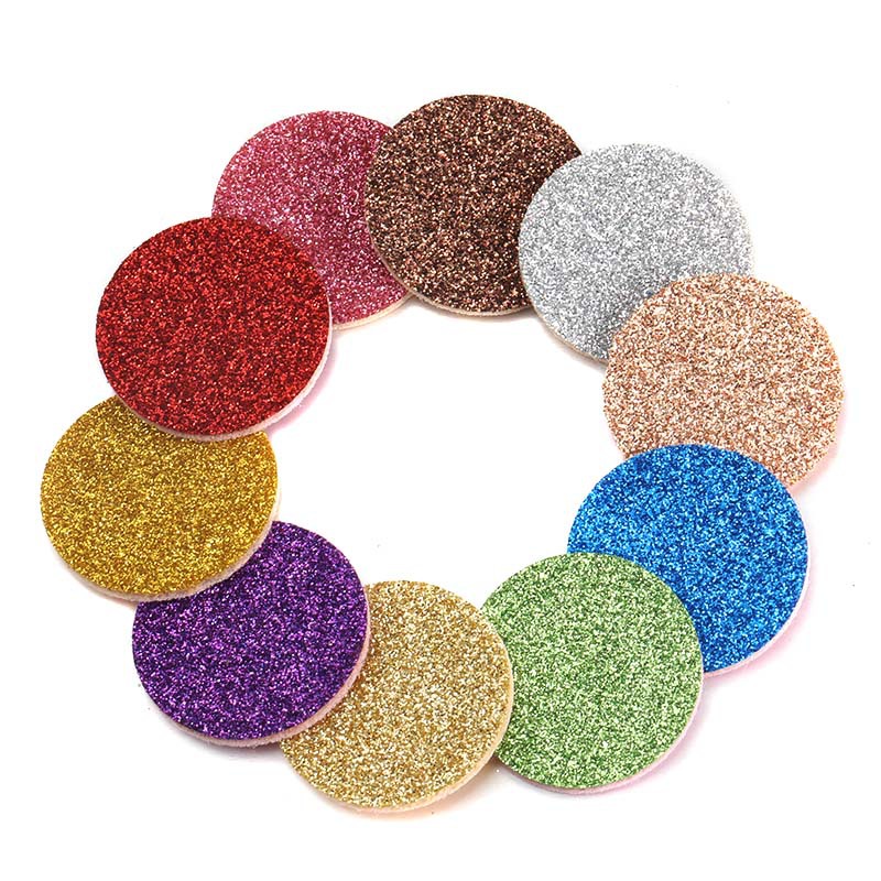 Circular glittery coasters in various colors arranged in a circular pattern on a white background.