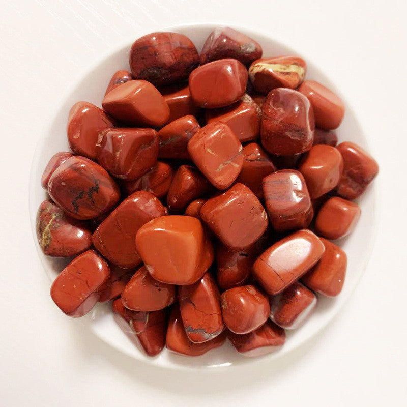 Red stones on a white plate
