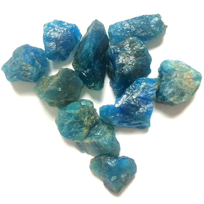 Blue rough gemstones on a white background