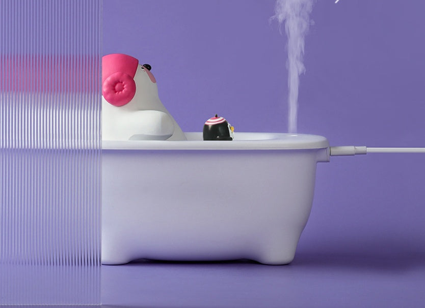 Small white duck-shaped humidifier with pink beak on a purple background