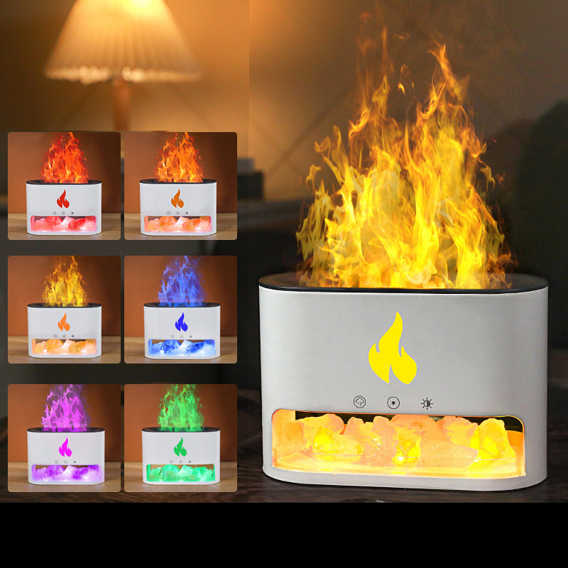 Tabletop fire pit with colorful flames and visible components on a wooden surface.