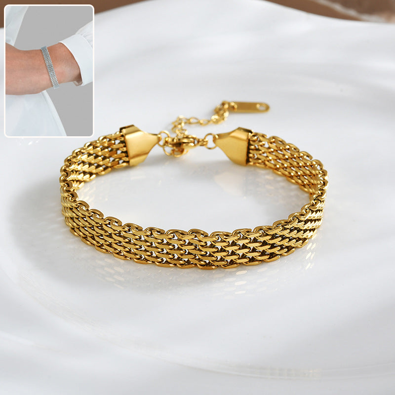 Gold chain bracelet on a white surface with an inset showing a wrist wearing a silver bracelet.